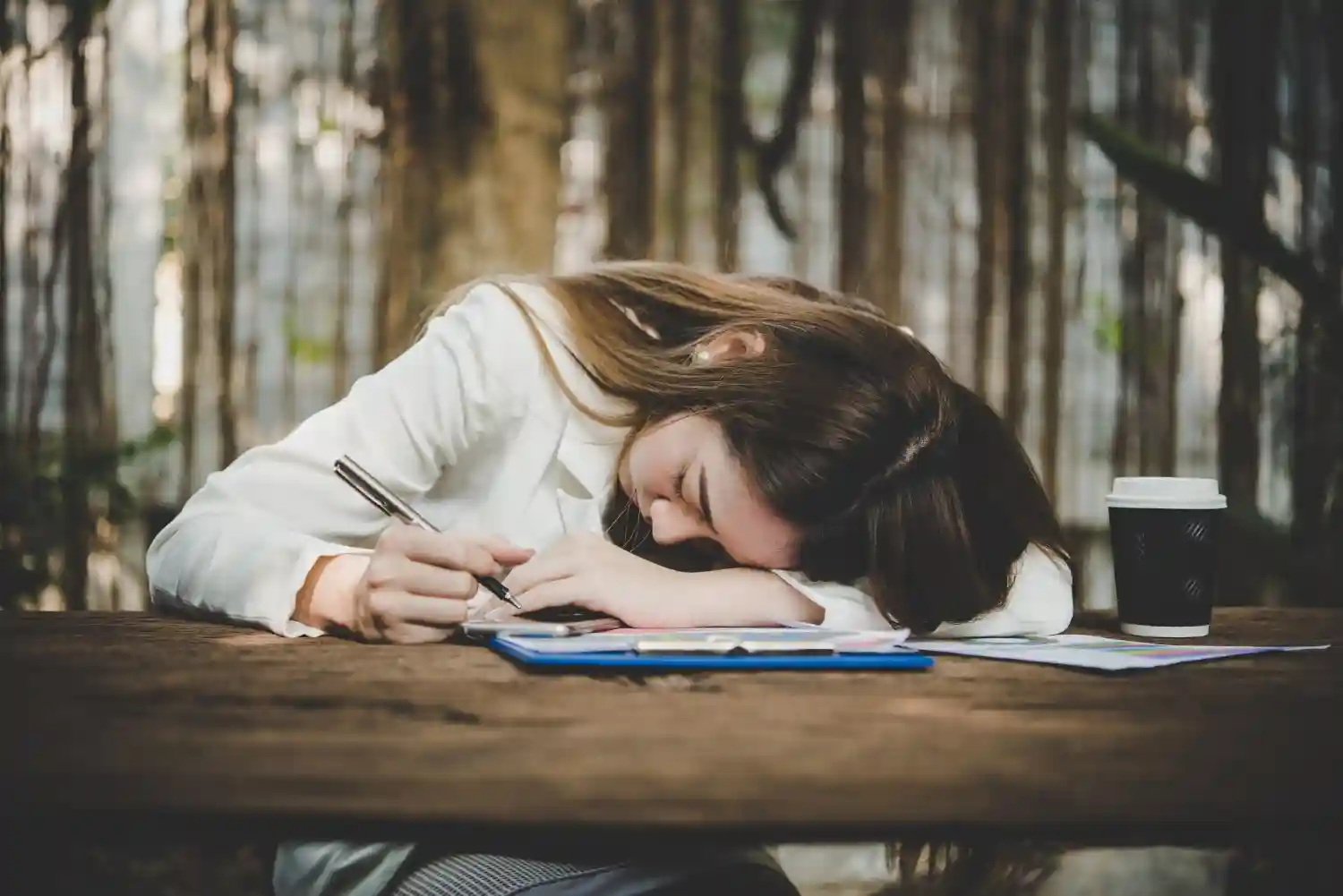 A young woman resting after a long stretch of writing